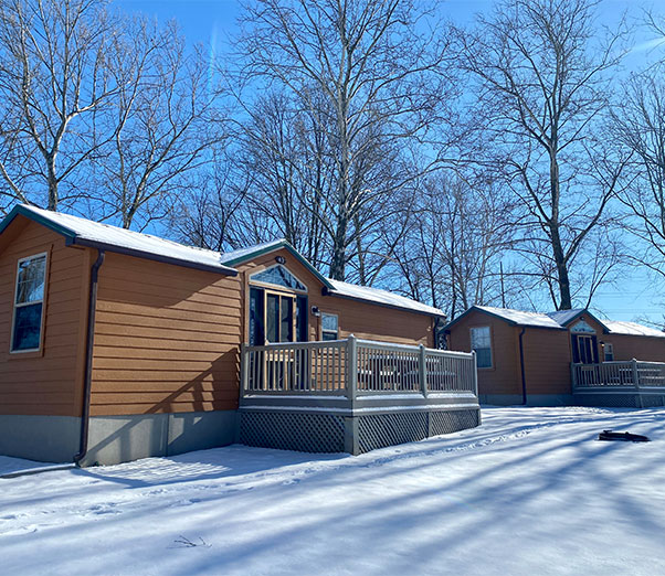 Family sitting around a fire making S